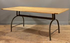 A modern dining table, solid oak top raised on wrought iron base with arched supports and stretcher: