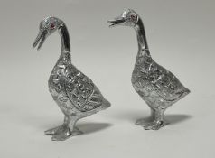 A pair of aluminium figurines in the form of ducks with carved feathers and painted red eyes (h.