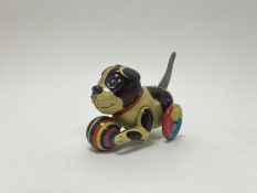 A vintage-style tin plate dog with wheels and ball to front, movement working with original box (