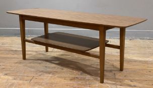 A mid-century teak coffee table, rectangular top with rounded edges over low-level shelf raised on
