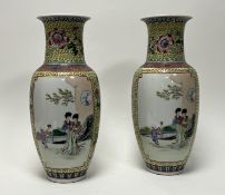 A pair of 20thc Chinese Famille Rose vases of shouldered tapered form, decorated with panels of