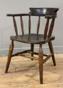 An early 20th century ash and elm Captain's chair, shaped bow back with spindles over saddle seat,