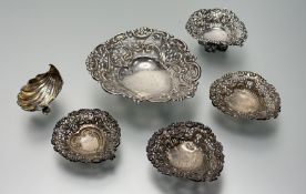 A pair of Victorian Birmingham silver heart-shaped pierced pistachio dishes with ribbon and C scroll