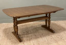 An Ercol elm Grand Refectory extendable dining table, rectangular top would curved edges with