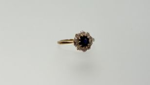 A yellow metal ring set circular facet cut deep blue sapphire approximately 0.75 within a surround