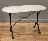 A modern French bistro table, white marble top raised on cast iron base with splayed supports and '