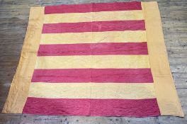 A Durham quilt in burnt umber and raspberry panelled design (223cm x 188cm)