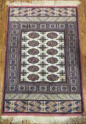 A modern Afghan Bokhara rug, central panel with two rows of guls, enclosed within a banded border of