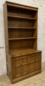 An Ercol Golden Dawn elm bookcase, moulded cornice over three adjustable shelves to front, on a base