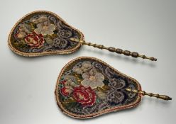 A graduated pair of Victorian bead work face fans, in floral design with gold painted handles. (