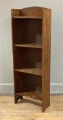 An Edwardian oak bookcase, of small proportions, arched top with four fixed shelves, on arched