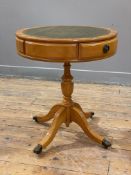 A reproduction yew drum table, faux-leather top with two frieze drawers, raised on baluster column