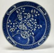 A Chinese 19th century Qing Dynasty blue and white charger with flowering prunus decoration to