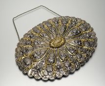 A Turkish white and gilt metal oval bridal trousseau mirror with scalloped border and chased back