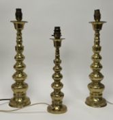 A pair of brass table lamps moulded with a turned spindle stem on round bases, plugs removed (h.