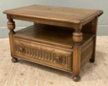 An Ercol Warwick elm TV stand, rectangular drop-leaf to top over open shelf, fitted with carved