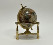 A Semi Precious gem stone table top globe secured within a brass gimble (h. 20cm)