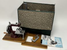 A vintage Miniature Essex portable sewing machine with some accessories, within a Dunne & Co case,