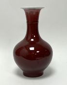 A Chinese 20th Century sang de boeuf bottle vase with Qianlong mark to base (h. 30.5cm)