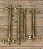 Two pairs of brass sash window pulls, with urn finials to ends: L. longer set 49cm shorter set 40cm