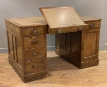 An Edwardian oak twin pedestal partner's desk, inset skiver to top over central drawer with fold-out