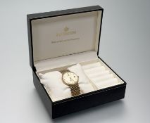 A Sovereign 9ct gold quartz wristwatch with gilt dial, baton hour markers and date complication on