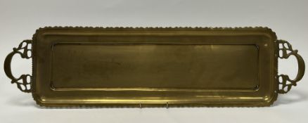 A 20th Century Eastern brass serving tray with pierced twin handles and shaped border (l. 73cm x