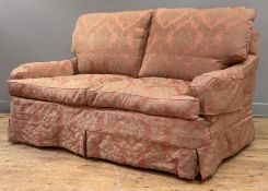 A Howard-style country house two-seater sofa, with soft red damask slip covers and cushions,