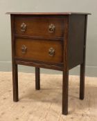 An Edwardian oak chest of drawers, fitted with two drawers to front, raised on reeded square