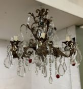 A modern French-style chandelier, eight arms with patinated finish and cut glass droplets, faux