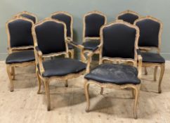 A set of eight French Louis XV-style beech dining chairs, six plus two carvers, black leatherette