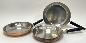 A pair of Swiss Culinox copper and stainless steel frying pans with brass and plastic handles,