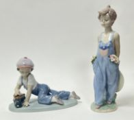 A Lladro porcelain figurine 'All Aboard', modelled as a young boy playing with a train set, No.