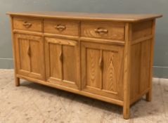 An Ercol elm sideboard dresser base, fitted with three drawers over three inset cupboard doors to