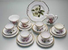 A Spode part tea service with various hand-painted flowers to centre with gilt rim comprising, a