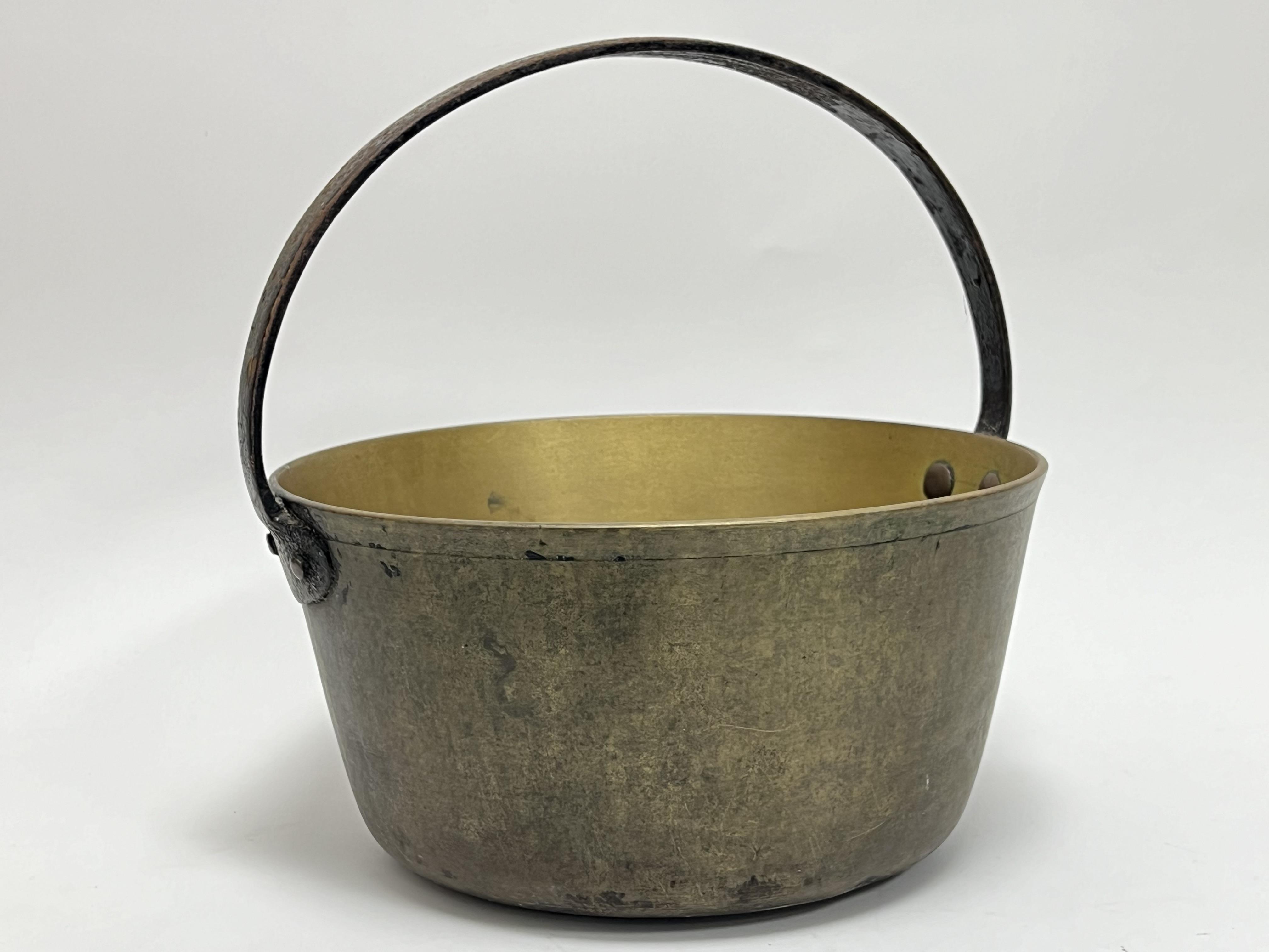 A Victorian brass jam/jelly pan with loop handle (h. 31cm)