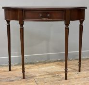 A reproduction bow front console table, by Bowlings, with single frieze drawer and raised on tapered