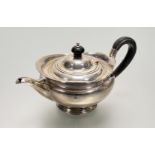 A late Victorian Sheffield silver helmet-shaped tea pot in the classical style with dark-stained