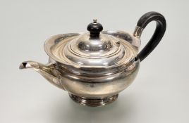 A late Victorian Sheffield silver helmet-shaped tea pot in the classical style with dark-stained