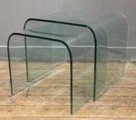 A set of modern glass nesting tables, arched tops and square sides (a/f chip to edge): H. 42cm L.
