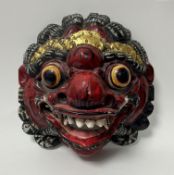 A Balinese 'Barong' carved wooden mask, depicting the 