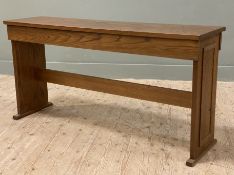 A modern oak organ stool, hinged seat with storage to interior, raised on trestle supports and