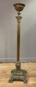 An Edwardian brass column oil lamp base, pierced basket to top over Corinthian capital and fluted
