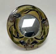A Chelsea Pottery framed circular wall-hanging mirror by Joyce Morgan, decorated with foliate detail