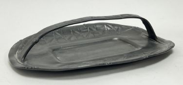 A Tudric Arts and Crafts pewter cake basket with single arched handle and repeated stylized