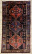 A hand-knotted Persian Ardabil rug, central panel with three medallions enclosed within a multiple