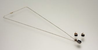 A silver gilt pendant set cushion cut blue stone within a surround of diamond points: l. x 1cm on