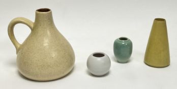 A collection of studio pottery vessels, comprising a stoneware pitcher of squat form with handle