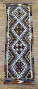 A hand-knotted Chobi kilim runner, central panel with four geometric medallions, multicoloured