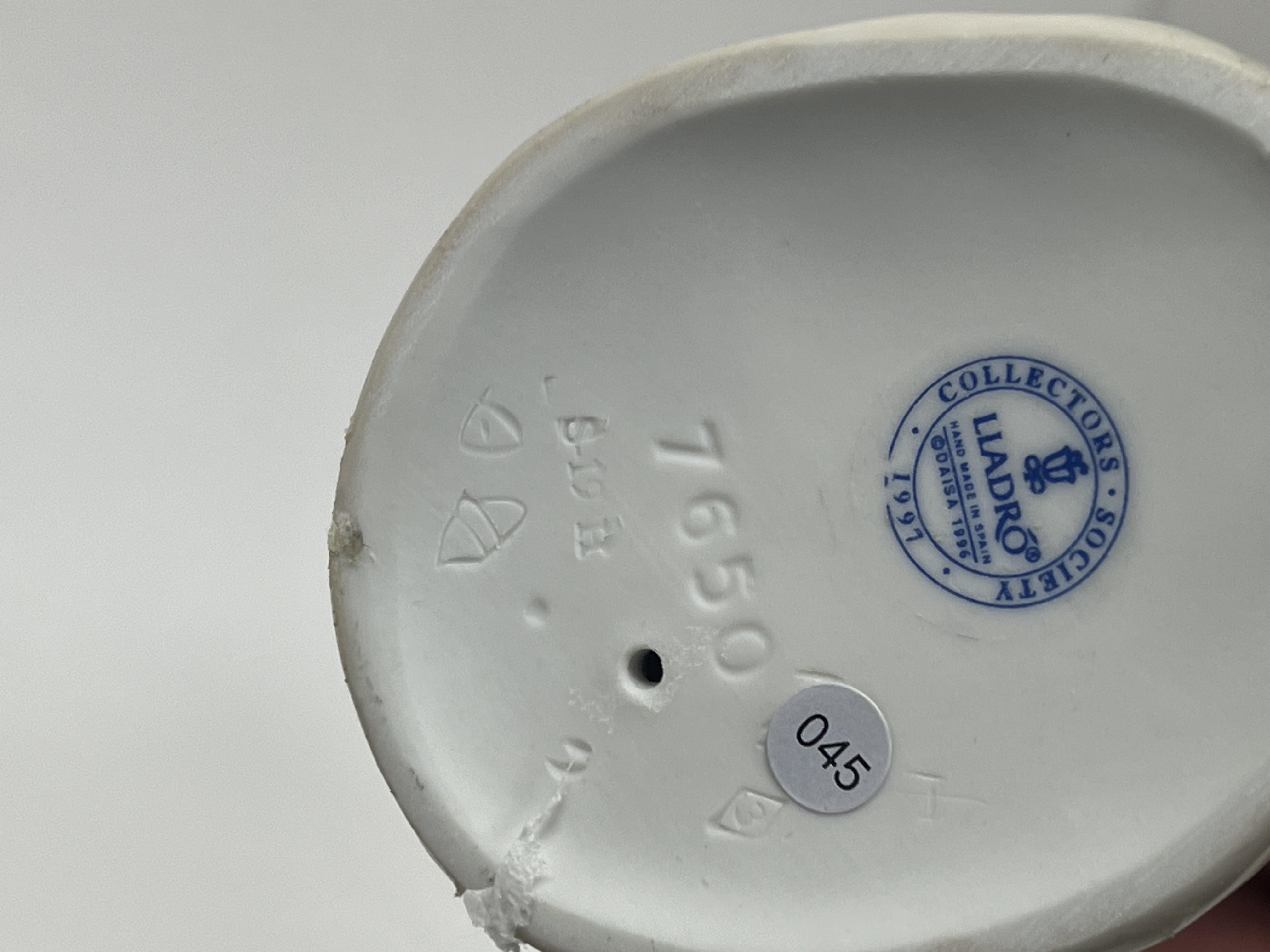 A Lladro porcelain figurine 'All Aboard', modelled as a young boy playing with a train set, No. - Image 5 of 6